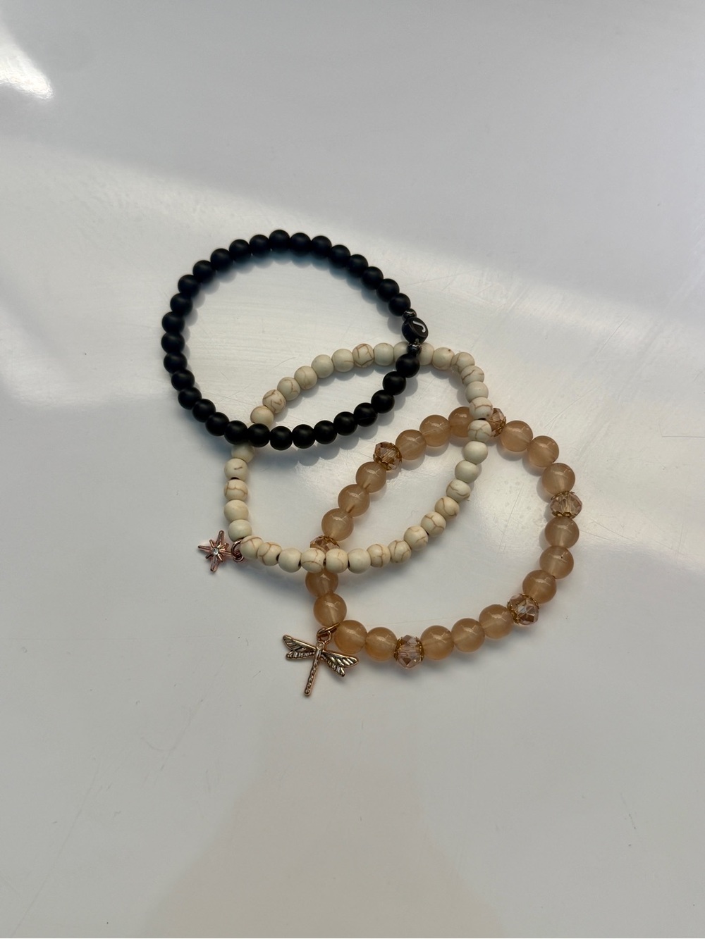 Beaded Bracelet Stack in Black, Cream & Peach with Charms (three-piece set)
